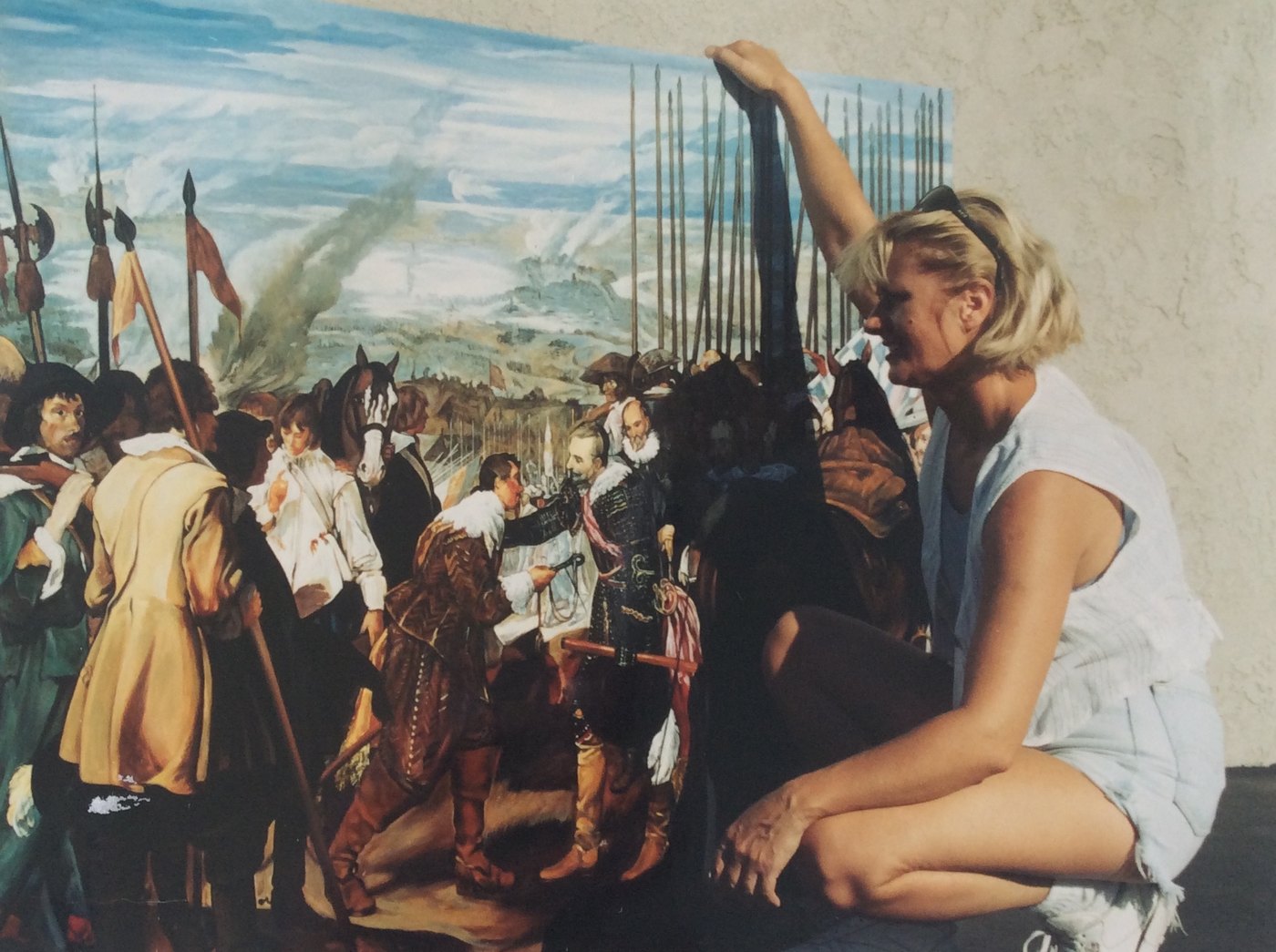 Janina Pazdan seated beside her full-scale interpretation of The Surrender of Breda in the studio