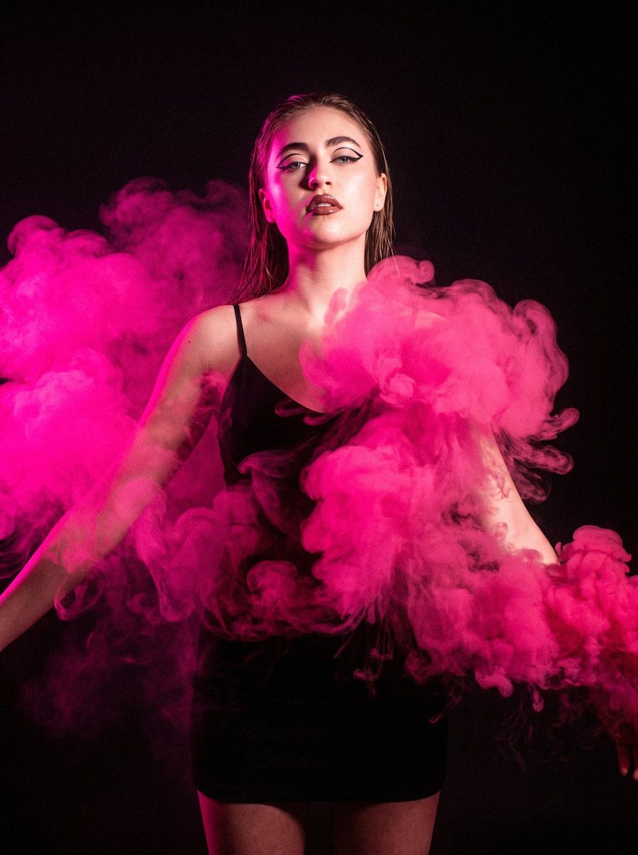 Victoria Grace wrapped in a plume of pink smoke