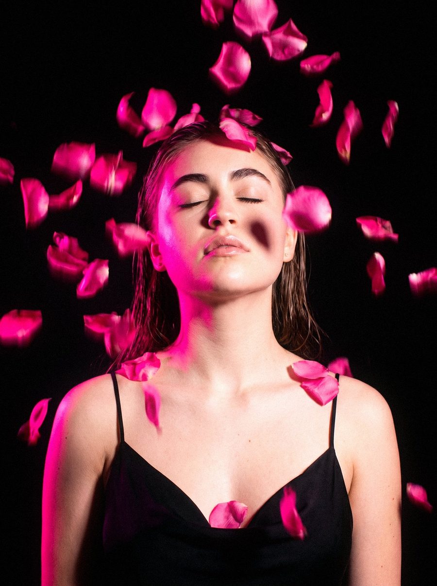 Victoria Grace with pink petals falling around her